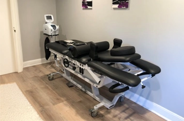 Chiropractic Doylestown PA Decompression Table HP Spinal Decompression Table In Room With Wood Floors And Grey Walls