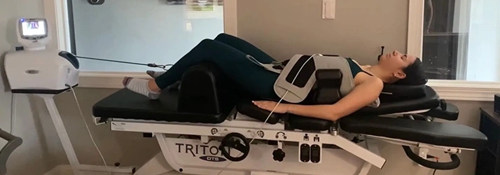 Chiropractic Doylestown PA Patient In Spinal Decompression Machine Woman Lying In Spinal Decompression Machine