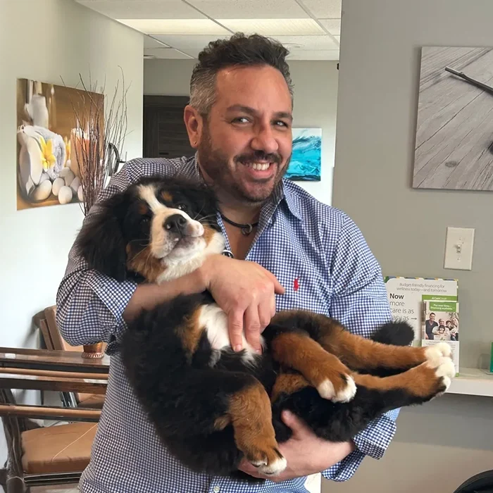 Chiropractor Doylestown PA Scott Solomon With Thorton Chiropractor Scott Solomon Smiling Holding Fluffy Service Dog Thorton